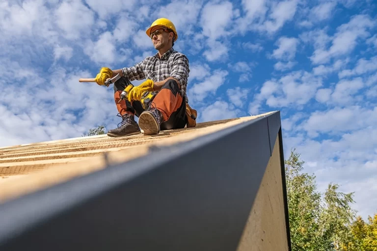 hiring a roofer - roofer on the roof of a house