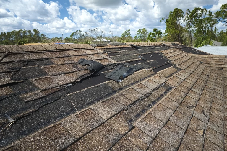 drone aerial view of residential house damaged roof with missing shingles